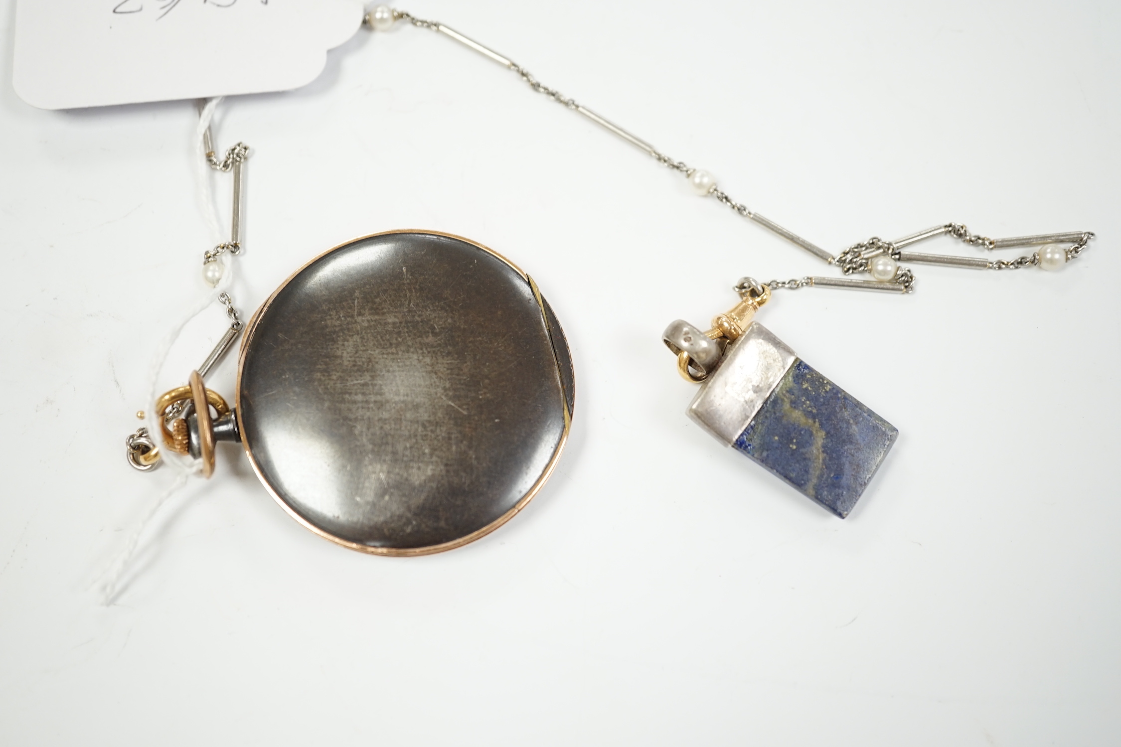 A gun metal and yellow metal dress pocket watch, on a white metal and seed pearl set chain, with lapis lazuli set fob.